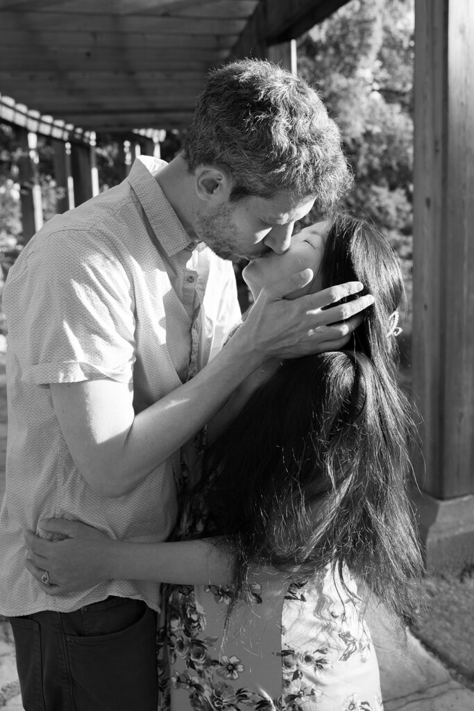 Black and white photo of a man and woman kissing