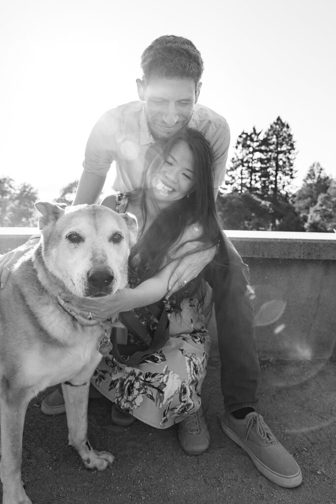 Black and white photo of a man, woman and their dog at a Berkeley Park