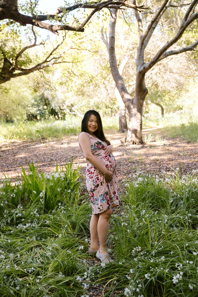 Pregnant woman holding her belly during her East Bay maternity photography session