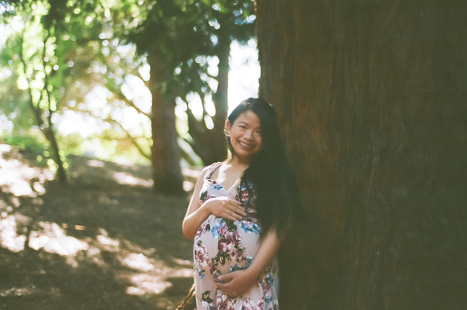 Pregnant woman holding her belly captured on 35mm film