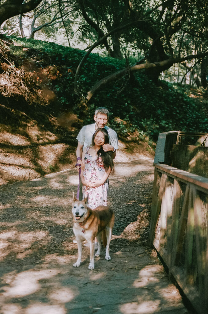 Couples and their dog walking together at a park in Berkeley captured on 35mm film