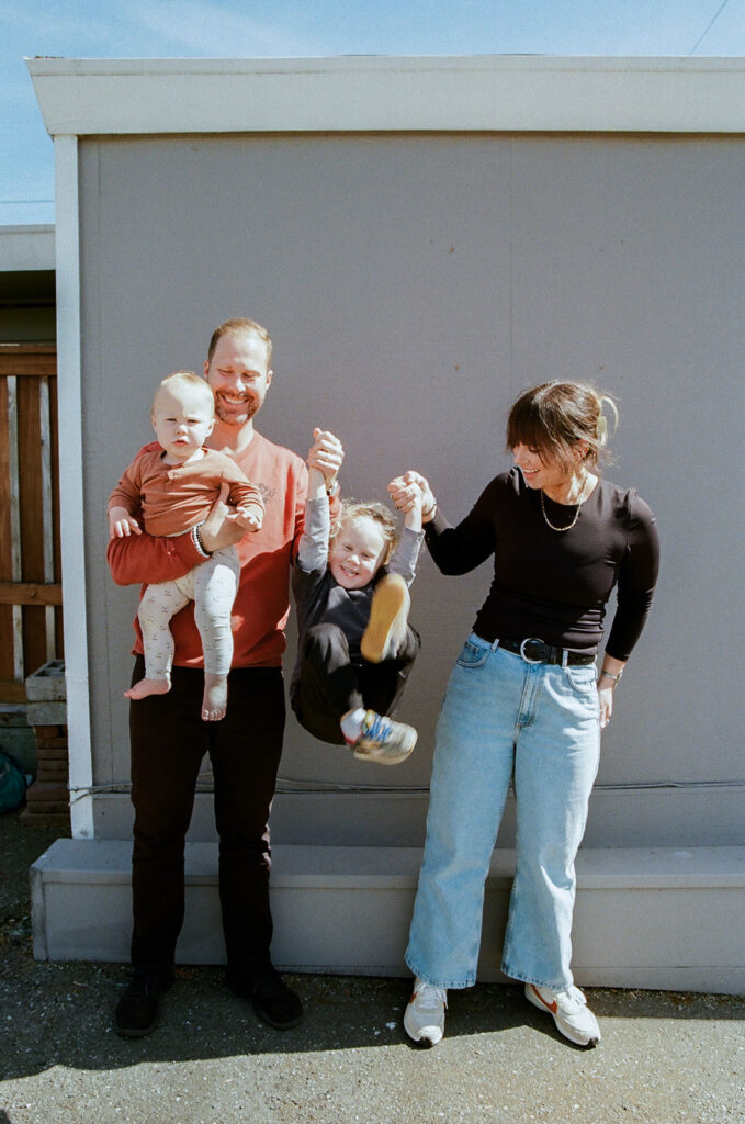 Family of four posing for their East Bay mini session at Morningtide shop in Albany, CA