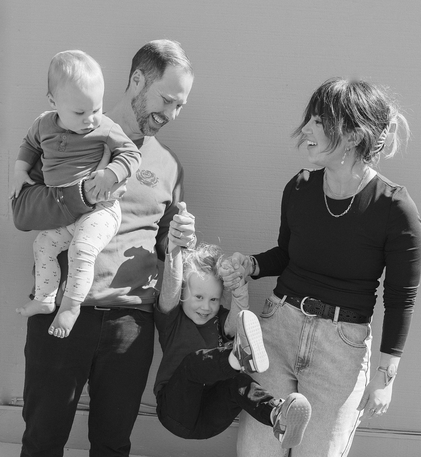 Black and white photo of a family of four being playful during their East Bay mini session