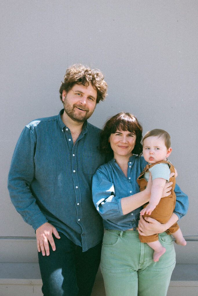 Family of three posing for their East Bay mini session at Morningtide Shop in Albany, CA