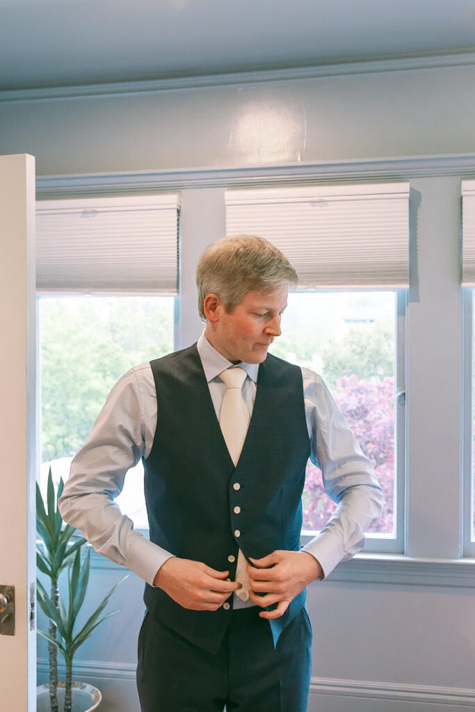 Groom getting ready for his intimate at-home East Bay wedding in Berkeley, California