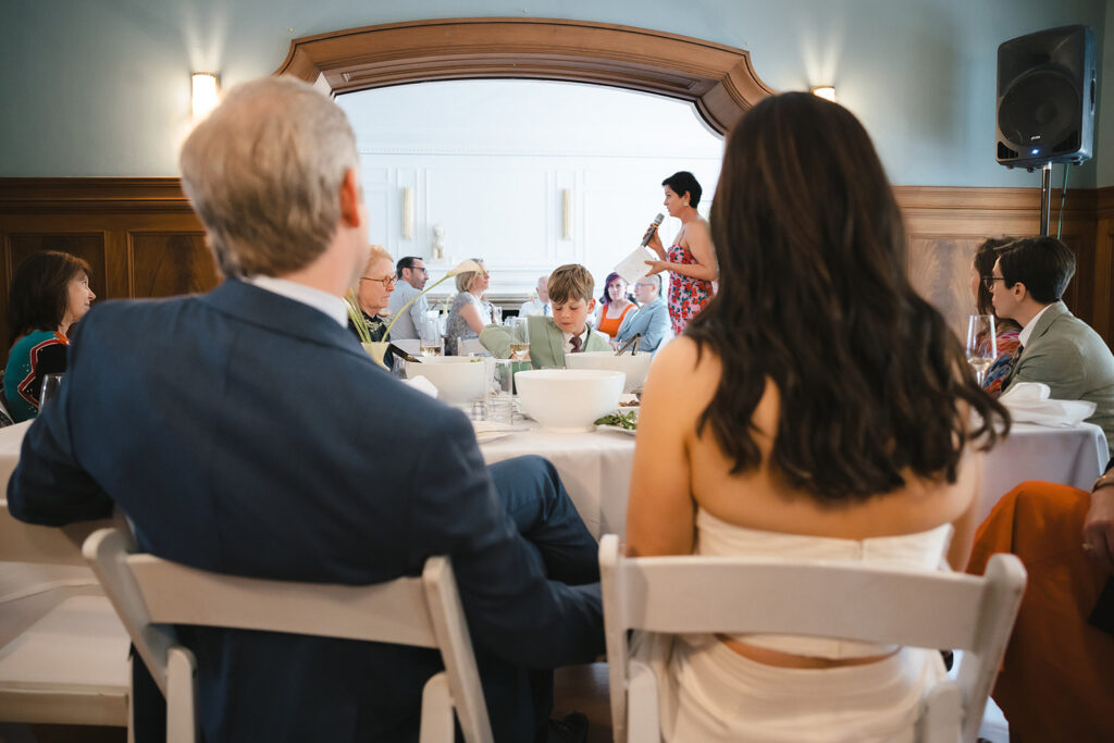 Bride and groom sitting at the head table during their intimate East Bay wedding reception in Berkeley, California