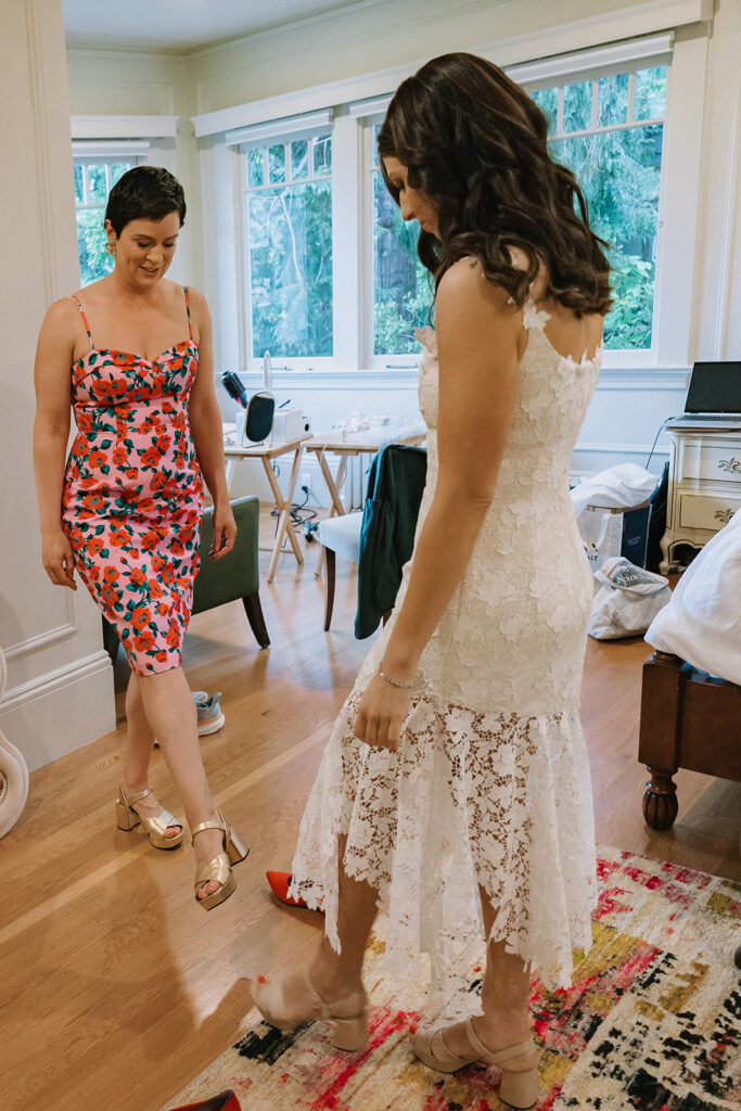 Bride comparing her shoes with wedding guest