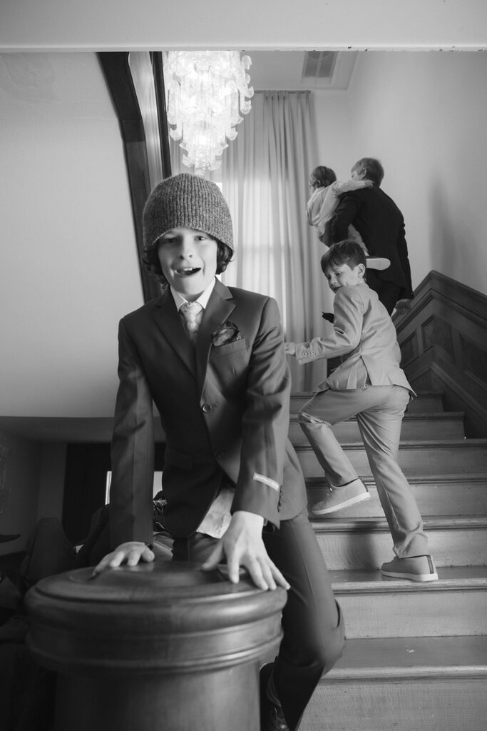 Black and white photo of kids playing on a staircase