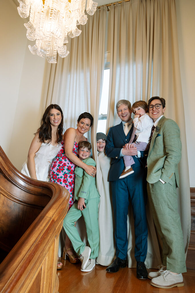 Bride and groom posing for photos with their family