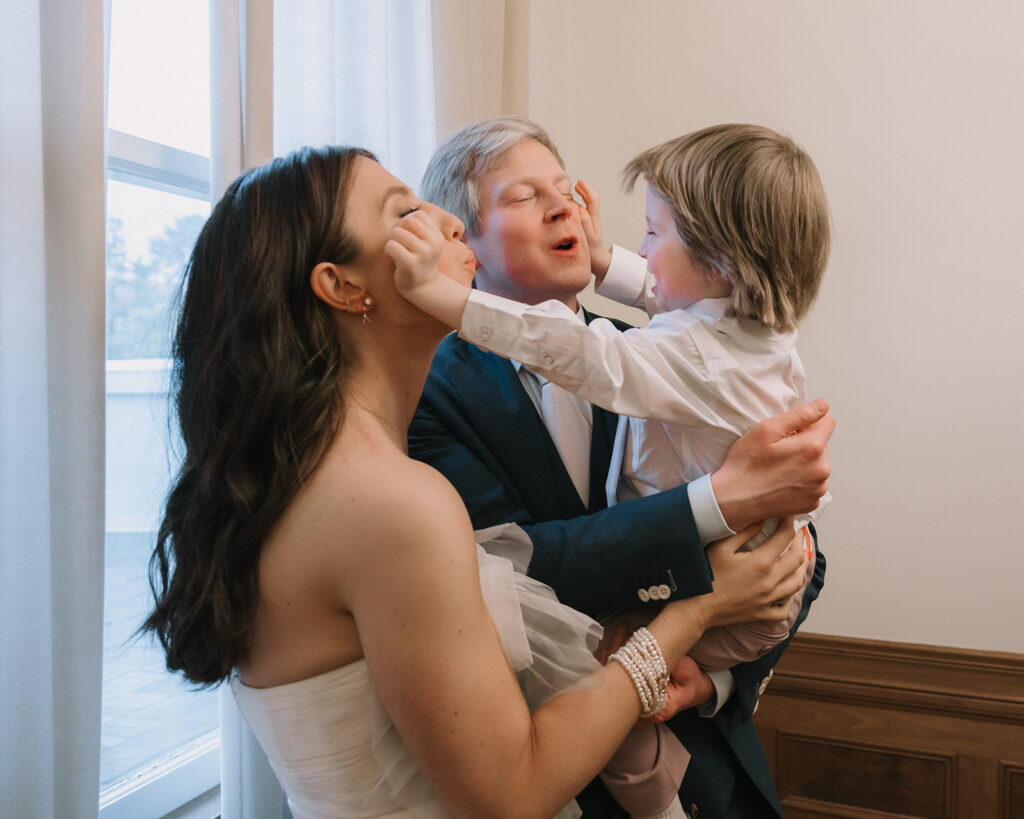 Bride and groom being playful with their son