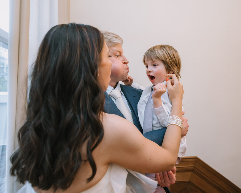 Bride and groom being playful with their son