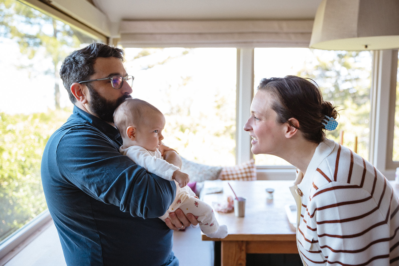 Mother and father playing with their newborn baby