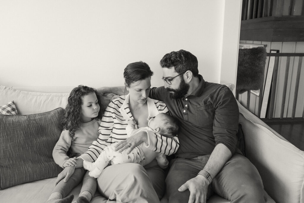 Black and white photo of a family of four during their at-home newborn photos in Berkeley, California