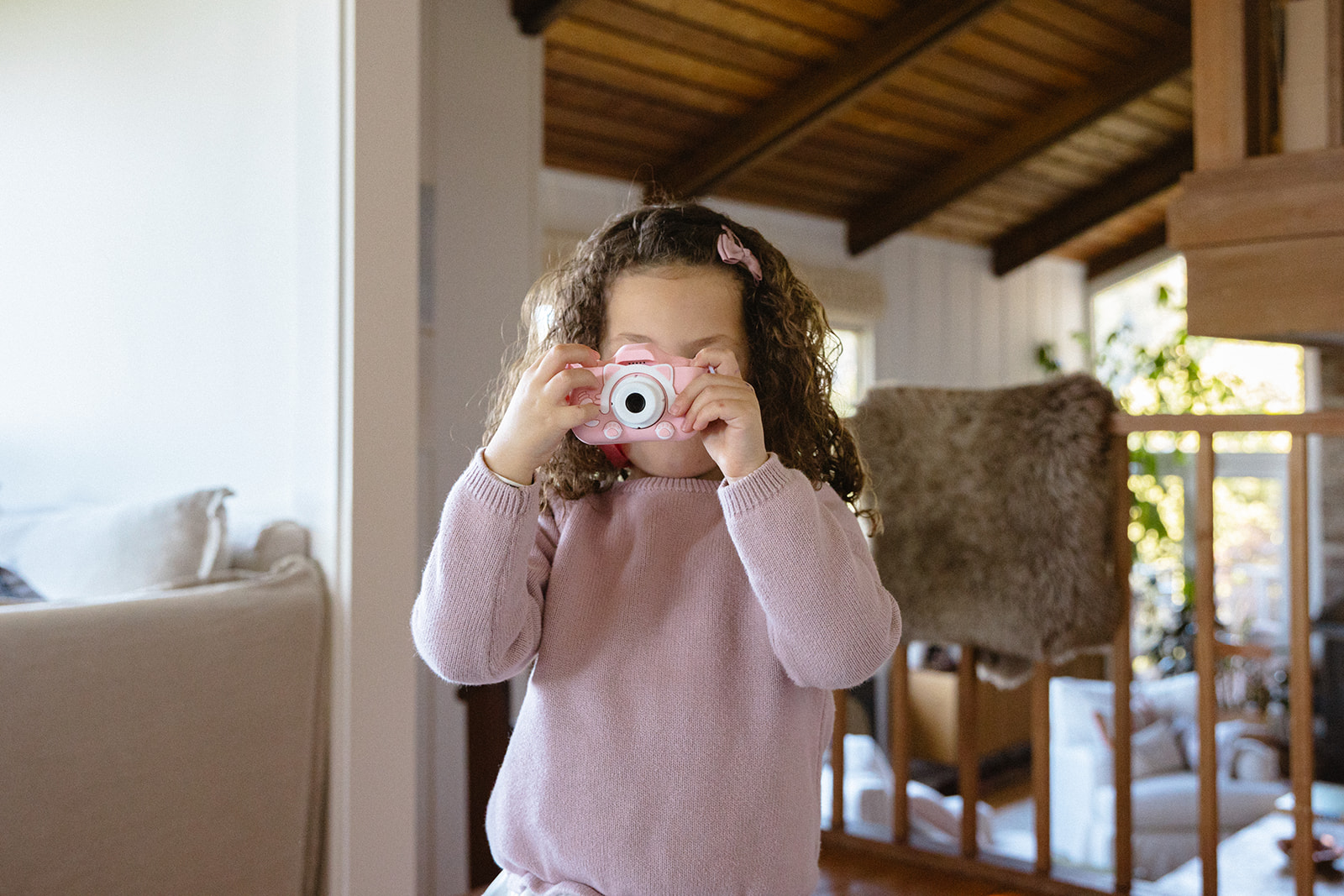 Little girl taking a photo of the photographer