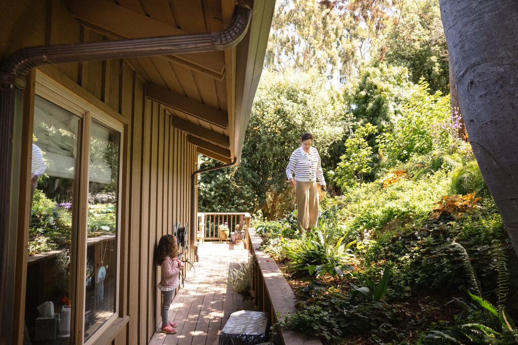 A mother and daughter outside in their backyard garden