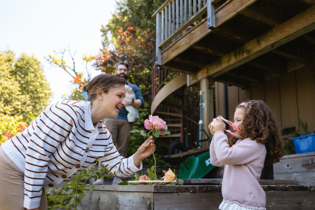 Mother and daughter picking flowers in their garden