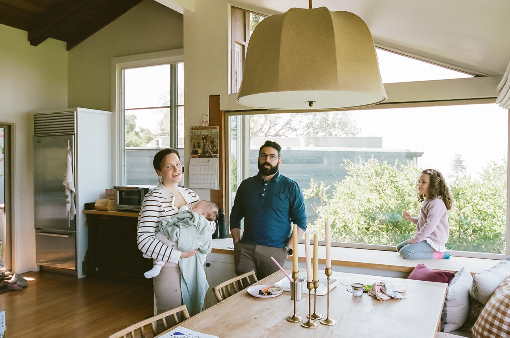 Family of four in their kitchen during their documentary newborn photos in Berkeley, California