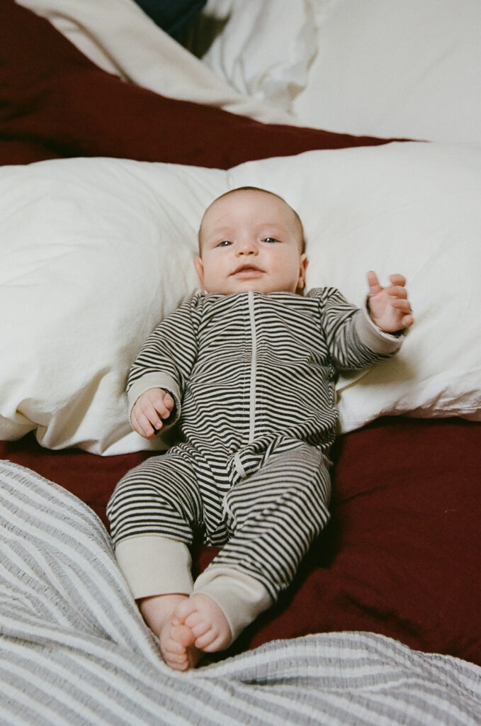 Newborn baby laying on a bed