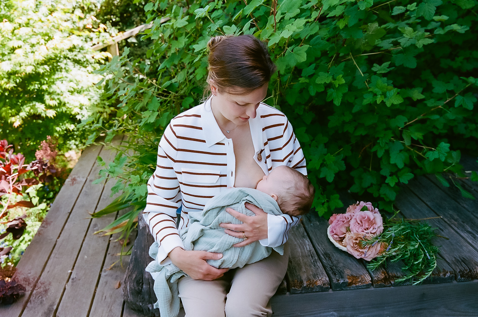 Mother breastfeeding her newborn baby captured on 35mm film