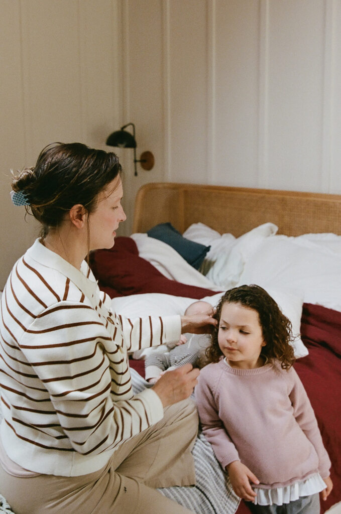 Mother doing her young daughters hair