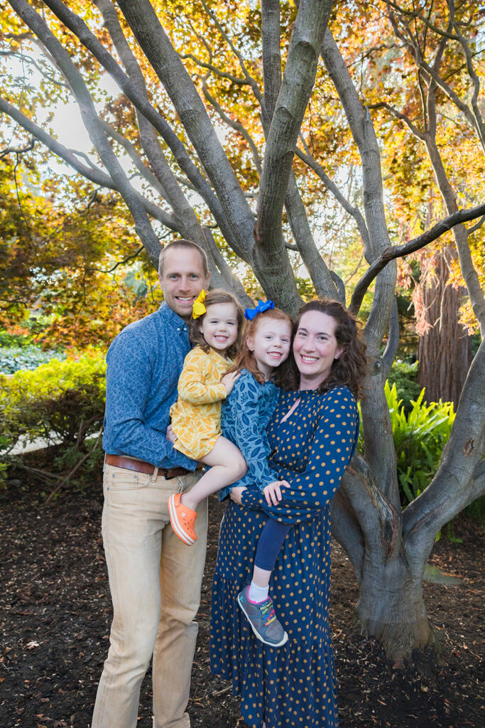 Family of four posing for their outdoor Piedmont Park family photos in the East Bay of California 