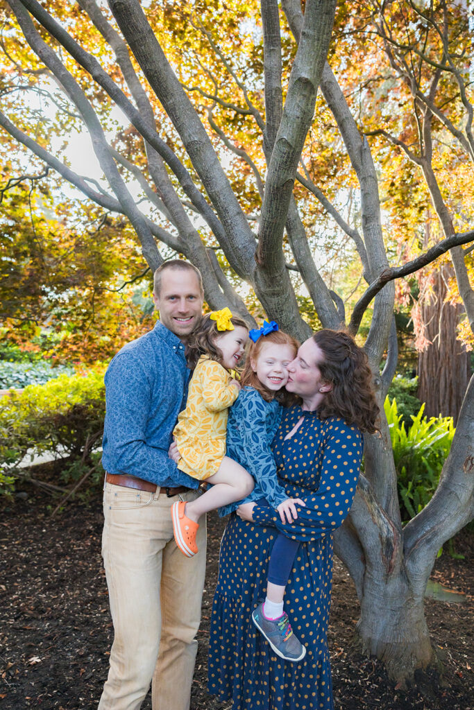 Family of four posing for their outdoor Piedmont Park family photos