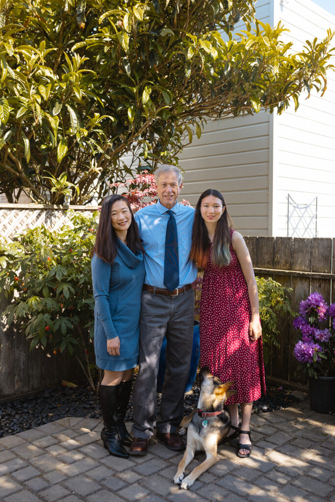 Family of three and their dog posing for their at-home family photos in San Francisco, California