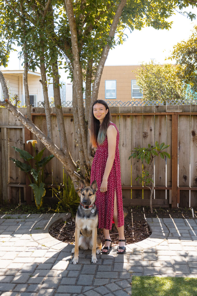 Girl posing with her German Shepard during her at-home family photos in San Francisco, California