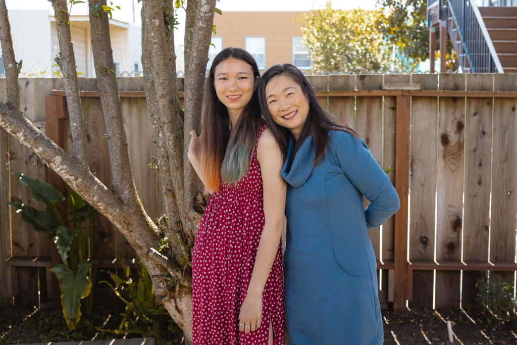 Mother and daughter posing for photos in their backyard