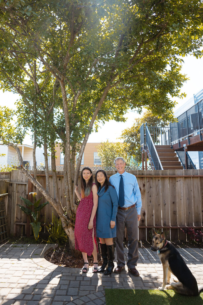 Family of three and their dog posing for their at-home family photos in San Francisco, California