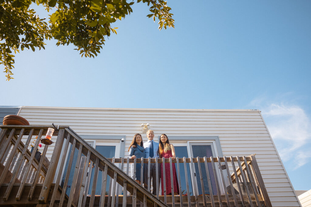 Family of posing on their stairs for their at-home family photos in San Francisco