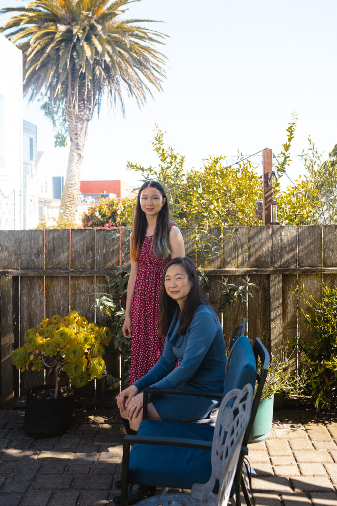 Mother and daughter together in their backyard 