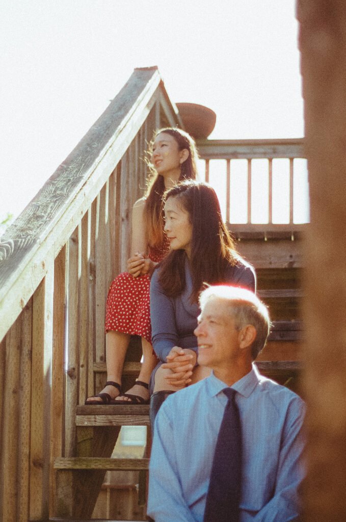 Family of three sitting on their stairs for their at-home family photos in San Francisco captured on film