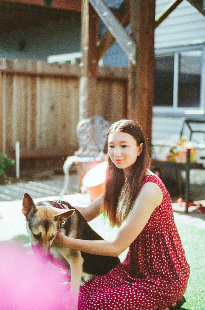 Film photo of a young girl posing with her German Shepherd 