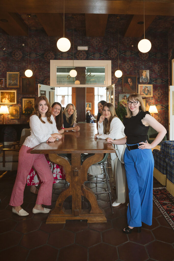 Group of women from Road Scholar posing for their creative brand photoshoot at The Graduate Hotel in Berkeley, California