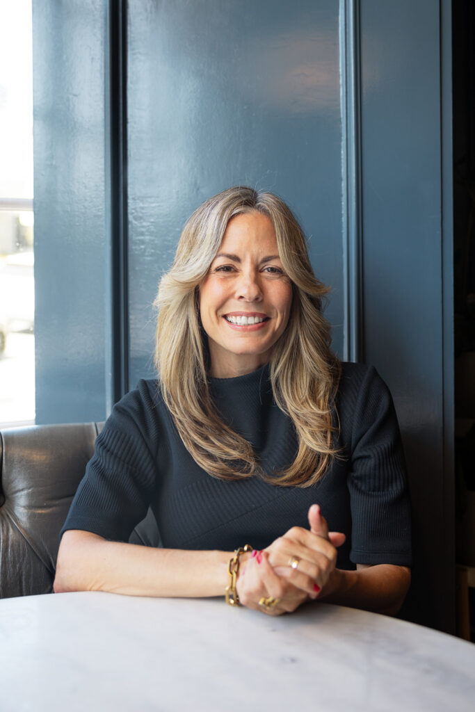 Woman sitting at a table for her brand photoshoot 