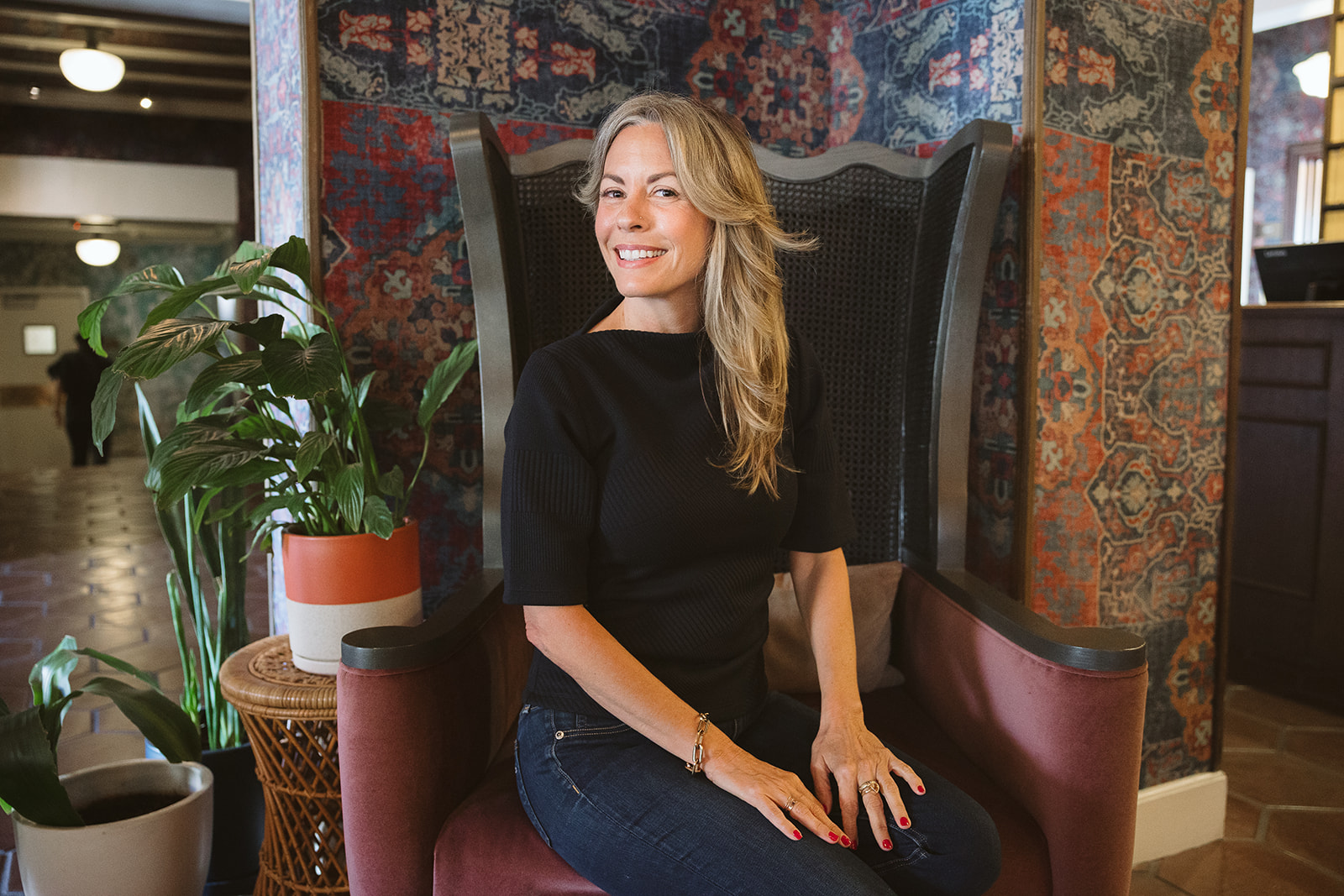 Woman posing for her brand photoshoot in a chair at The Graduate Hotel in Berkeley, California