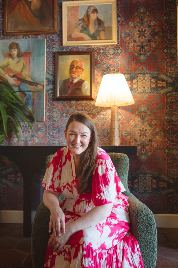 Woman sitting in a chair during her Bay Area brand photoshoot at The Graduate Hotel