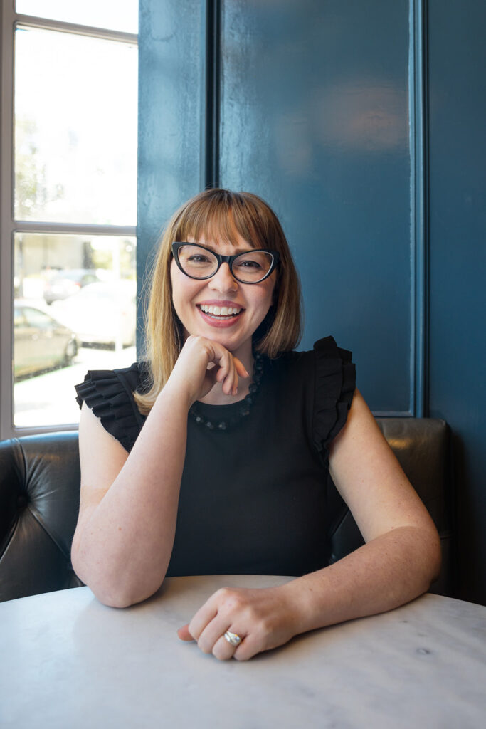 Woman posing for her brand photoshoot at a table