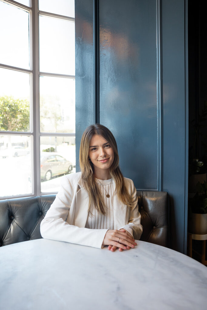 Woman posing for her branding photos at a table