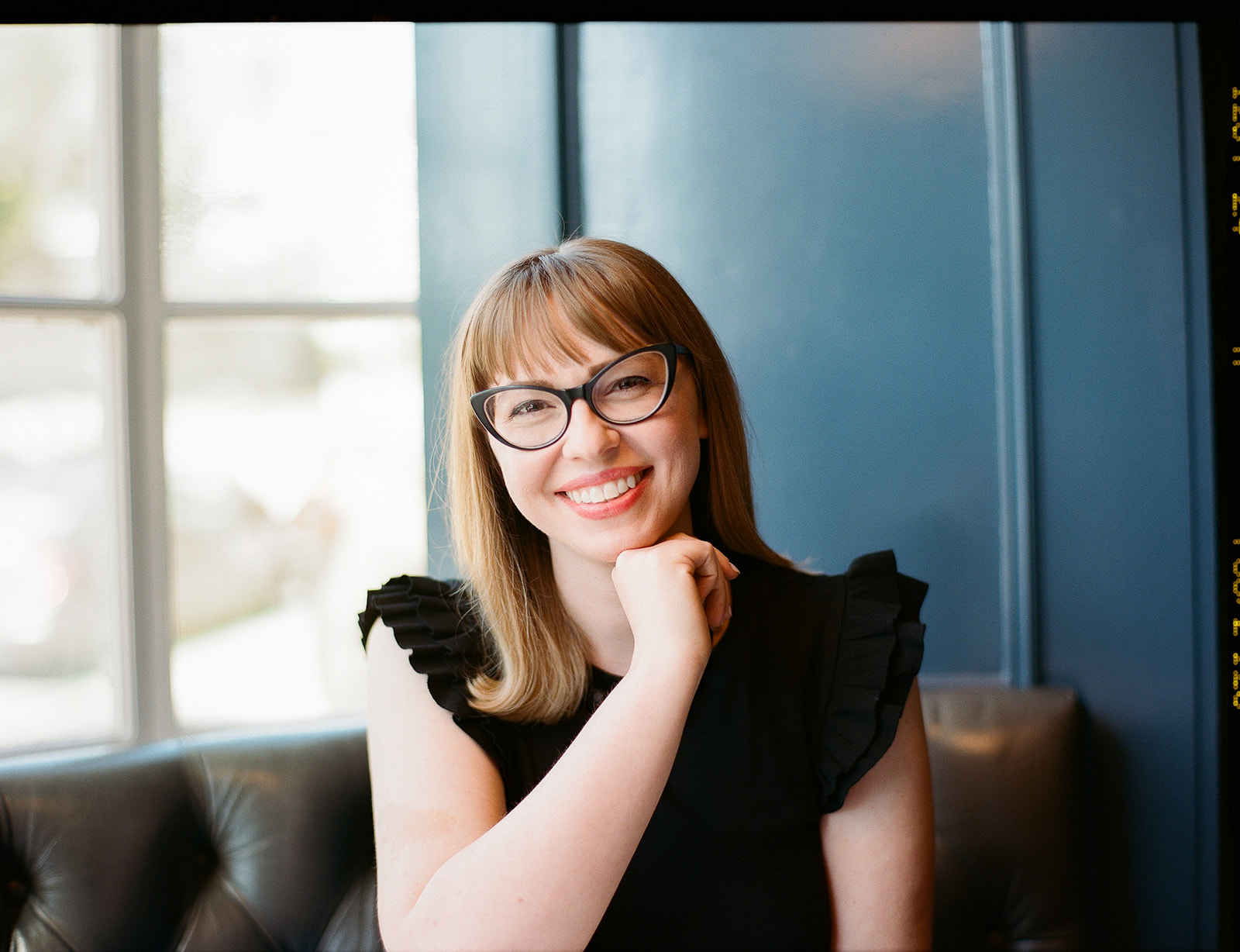 Woman smiling and posing for her branding photos captured on film