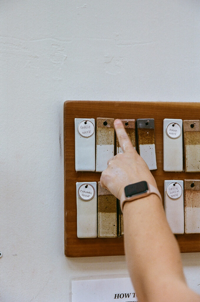 Woman pointing to colors on the wall