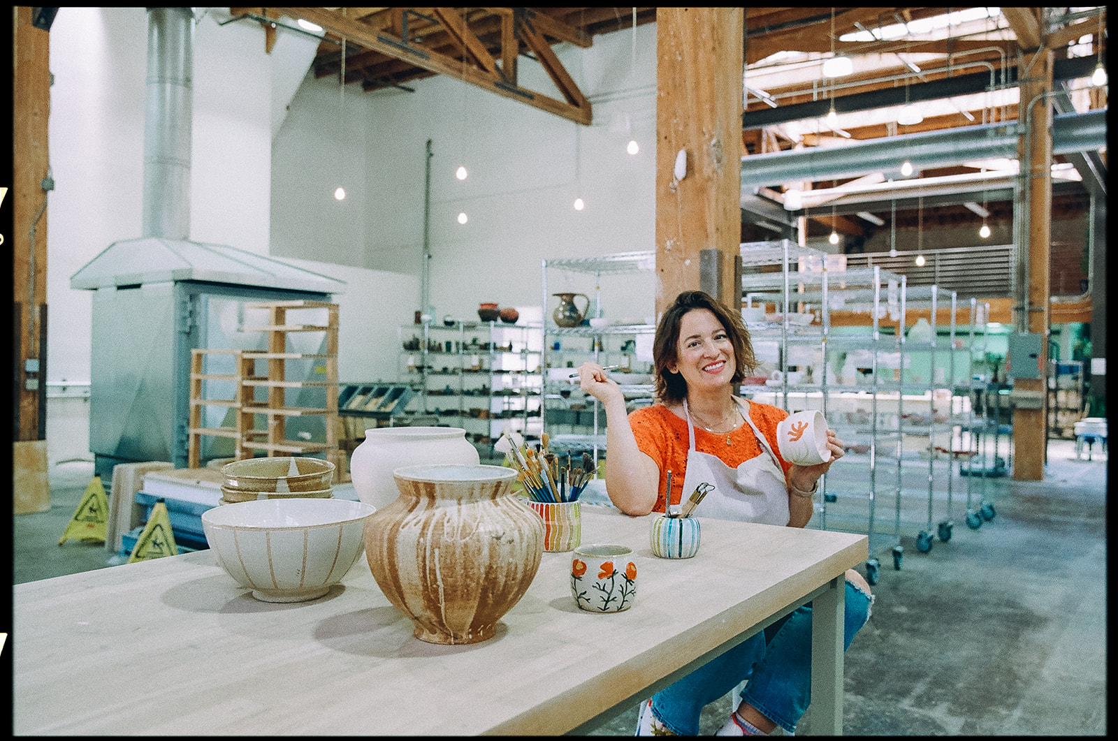 Woman painting her pottery captured on film for a creative branding session for The Pottery Studio San Francisco