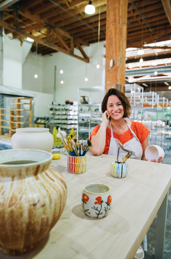 Woman painting her pottery captured on film for a creative branding session for The Pottery Studio San Francisco