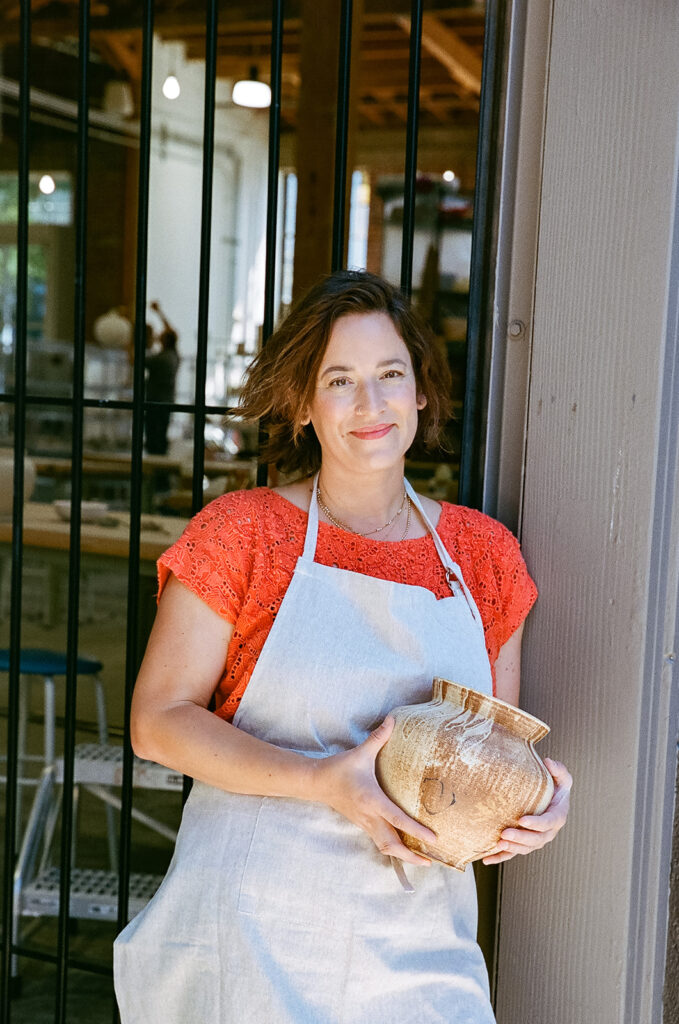 Woman holding her pottery pieces for her creative film branding photography session for The Pottery Studio San Francisco