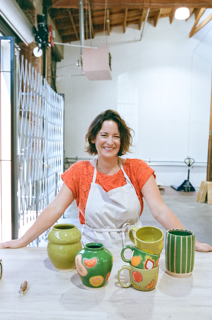 Woman posing with her pottery pieces for her creative film branding photography session for The Pottery Studio San Francisco