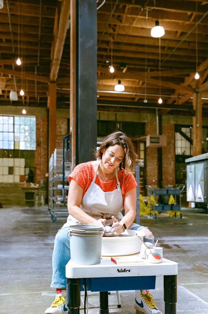 Woman creating with clay for creative film brand photography for The Pottery Studio San Francisco