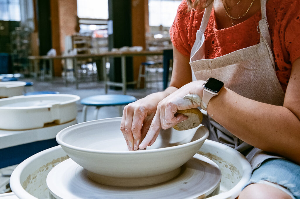 Woman creating with clay for creative film brand photography for The Pottery Studio San Francisco