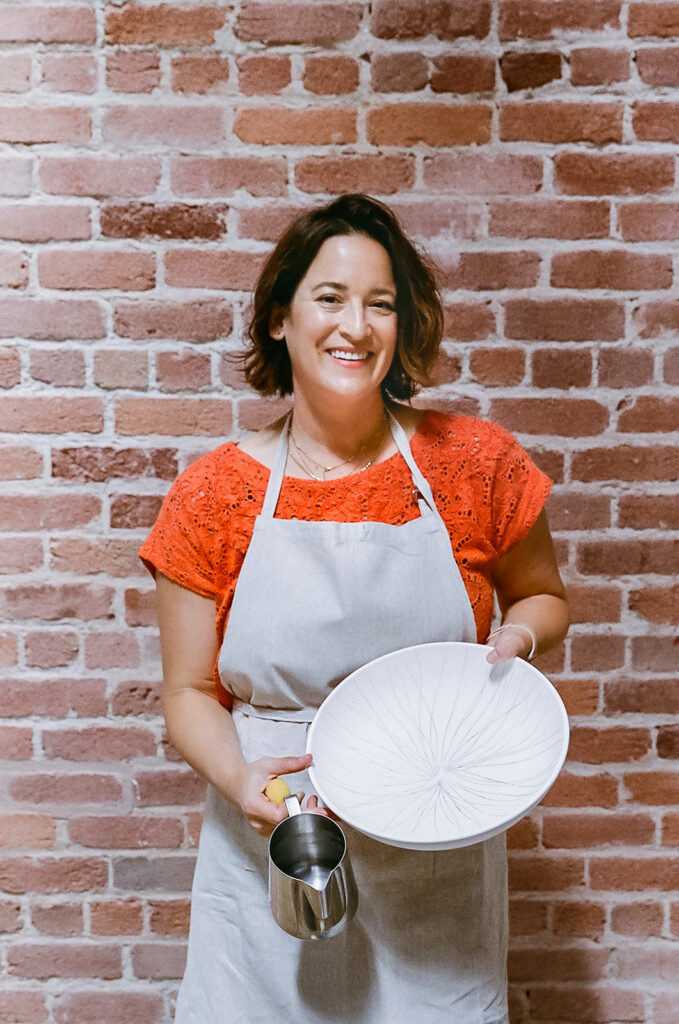 Woman holding up a bowl she made