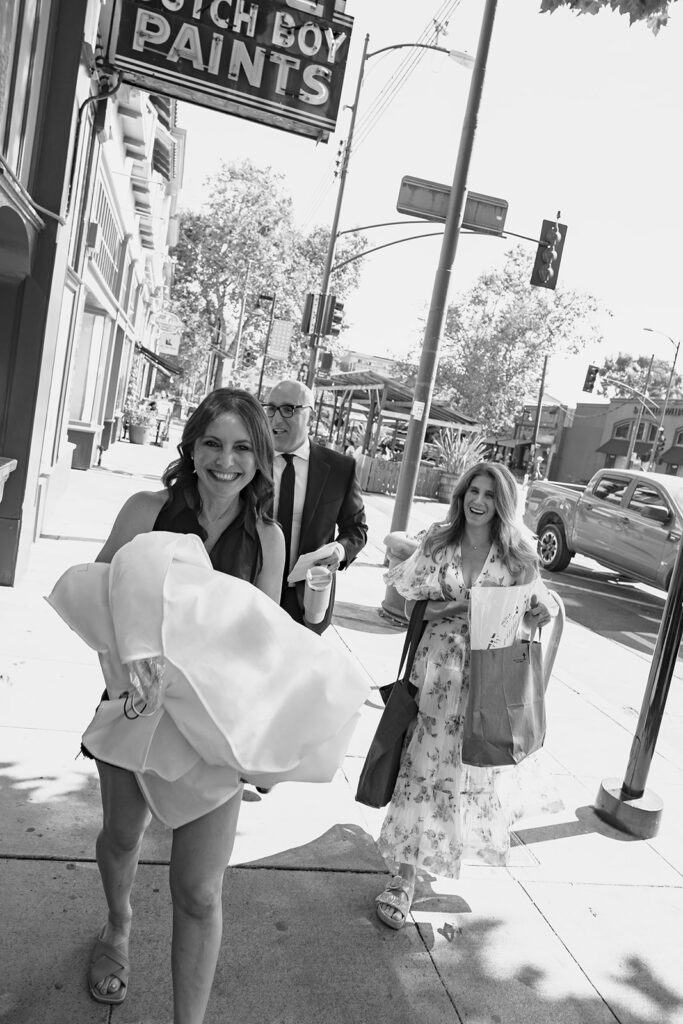 Black and white photo of a bride and groom arriving to their wedding